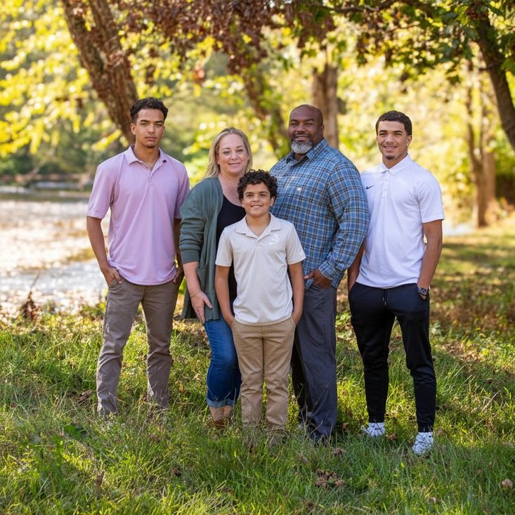 Family photo of Liza Grundy with her family, warm and welcoming, for the Our Story section.